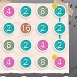 Numeroruudukko värikkäillä ympyröillä ja numerolla 16 keskellä, teipattu muistilapulle harmaalla taustalla