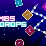 Kuvassa on neonvärisiä numeroituja laatikoita, valkoisia palloja ja teksti BOMBS DROPS violetilla taustalla