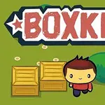 Hahmo seisoo kahden laatikon vieressä vihreällä taustalla, yläpuolella on teksti BOXKID