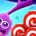 Violetti, iloinen hahmo, jonka pitkät tuntosarvet ulottuvat useiden puna-valkoisten pyöreiden karkkien yläpuolelle