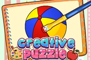 Värikäs pallo ja sivellin muistikirjan sivulla, jossa lukee creative puzzle