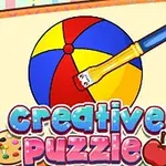 Värikäs pallo ja sivellin muistikirjan sivulla, jossa lukee creative puzzle