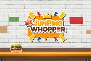 Valkoisella tiiliseinällä on värikkäitä tiililaattoja, keskellä Jumping Whopper -logo ja pöydällä hampurilainen