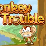 Piirrosmaisema, jossa veikeä apina seisoo meren äärellä viidakon reunalla, ja taustalla näkyy teksti Monkey in Trouble