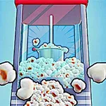 Popcorn-kone, josta valkoisia popcorneja putoaa ulos