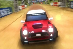 Rally Point 2 Punainen auto ajamassa hiekkarataa pitkin, ympÀrillÀ mainoskylttejÀ ja maaliviiva edessÀ