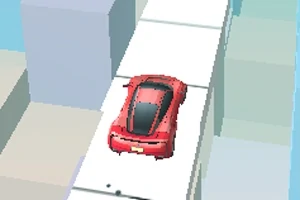 Punainen auto ajaa kapeaa valkoista tietä korkeiden kuutioiden keskellä