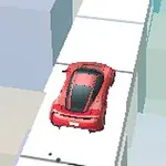 Punainen auto ajaa kapeaa valkoista tietä korkeiden kuutioiden keskellä