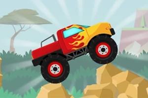 Punainen ja keltainen monsteriauto liekkikuvioilla ajamassa kivikossa, taustalla näkyy puita ja kukkuloita