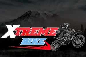 Motocross-kuljettaja hyppää motoristossa tummalla vuoristotaustalla, ja edessä on teksti Xtreme Bike